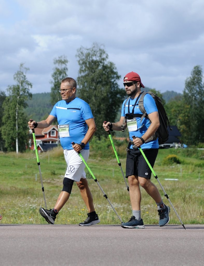 two men walking with poles